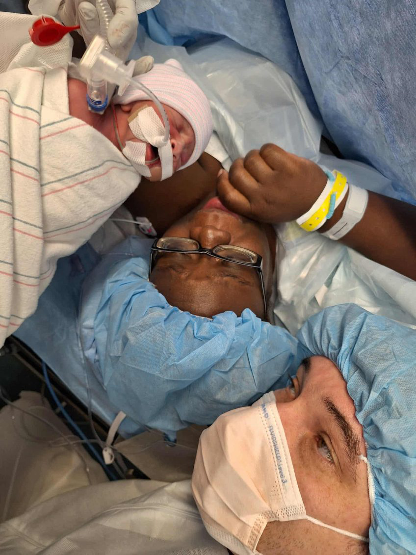 Kandra and Bernard moments holding Presley moments after she was born by c-section