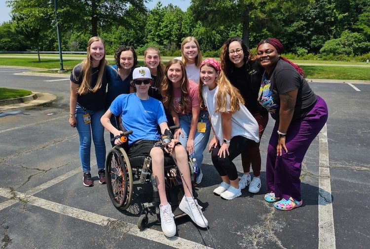 Occupational therapist students take picture with Cameran Pickett