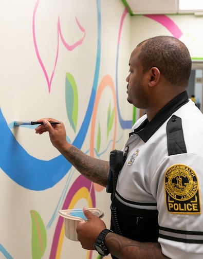security officer painting on the wall