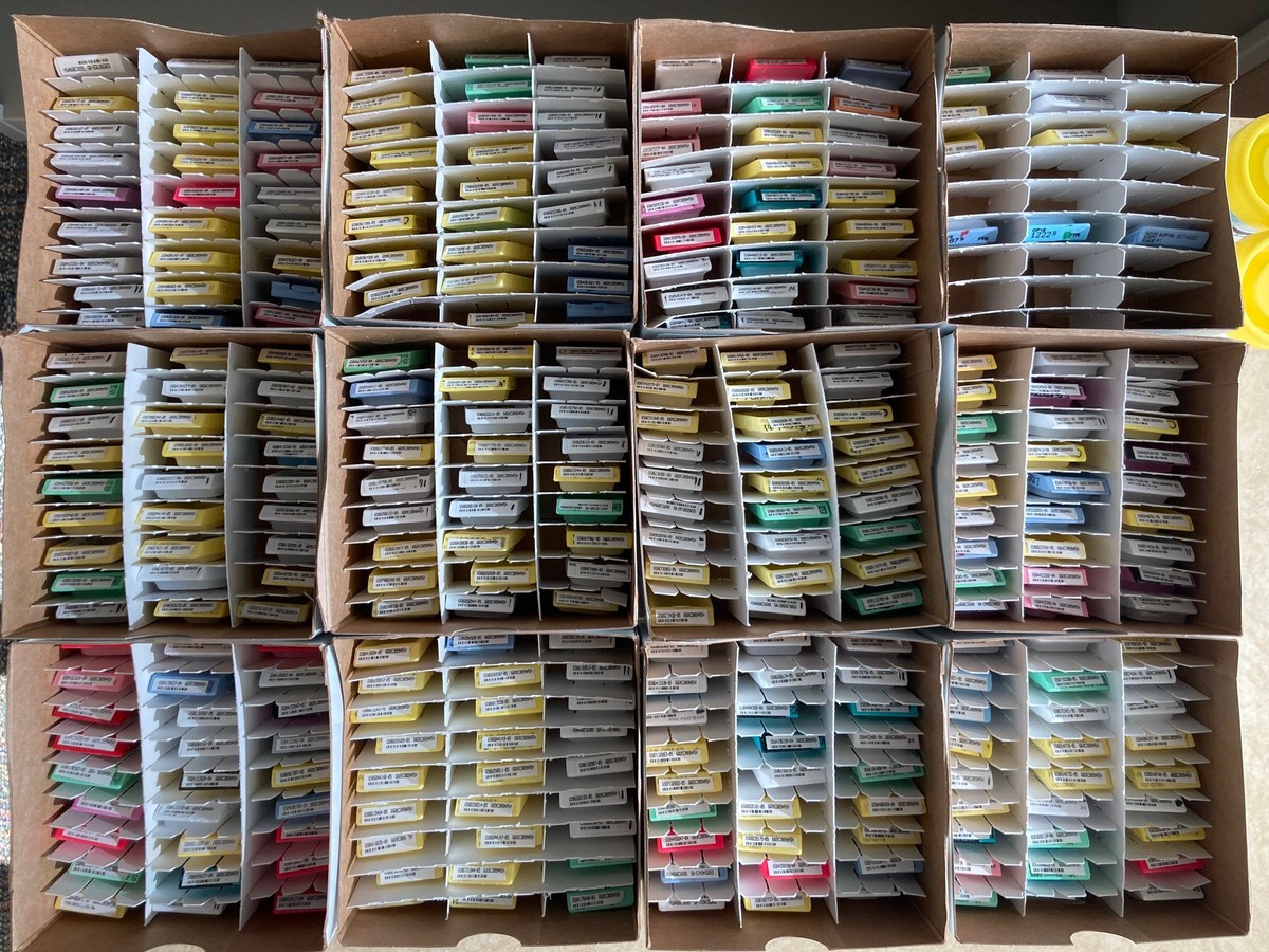 Small boxes of samples stacked on top of eachother inside of a cardboard box.