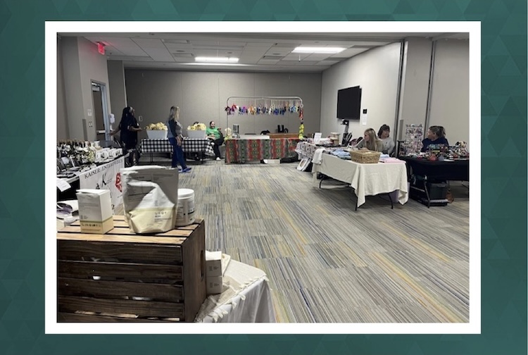 Hospital employees browse items crafted by employees for an indoor holiday bazaar.