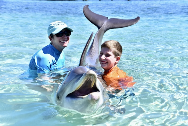 Dani holding a dolphin with her son