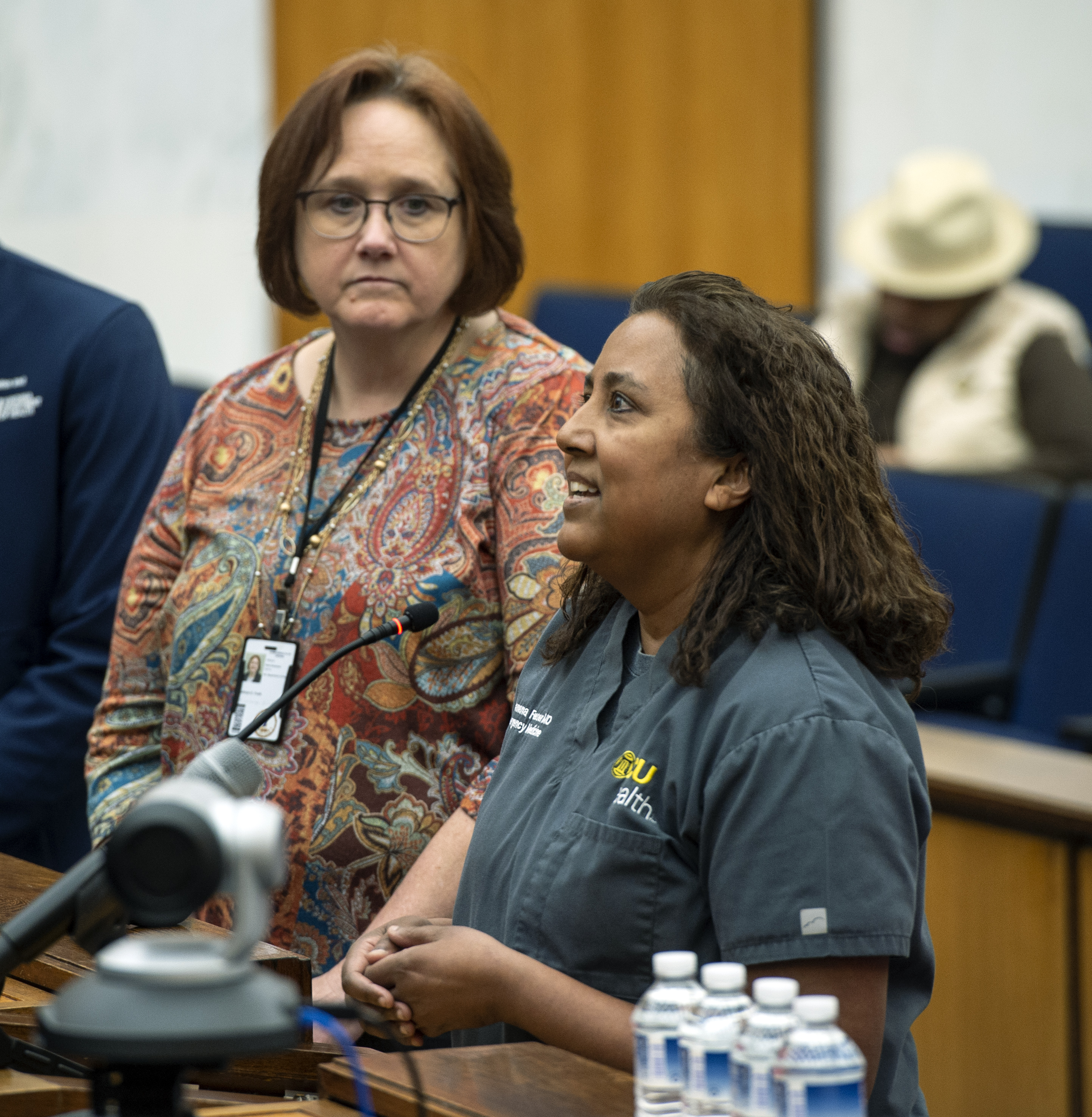 Female doctor speaks at a podium.