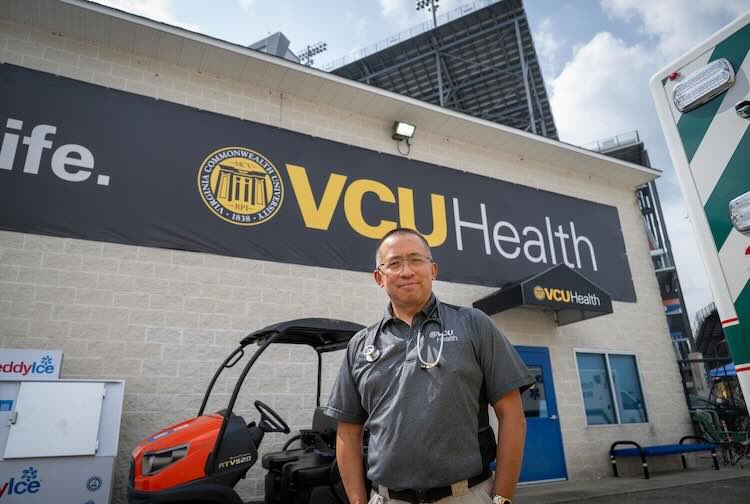 Dr. Yee stands outside the outfield care center at the Richmond Raceway.