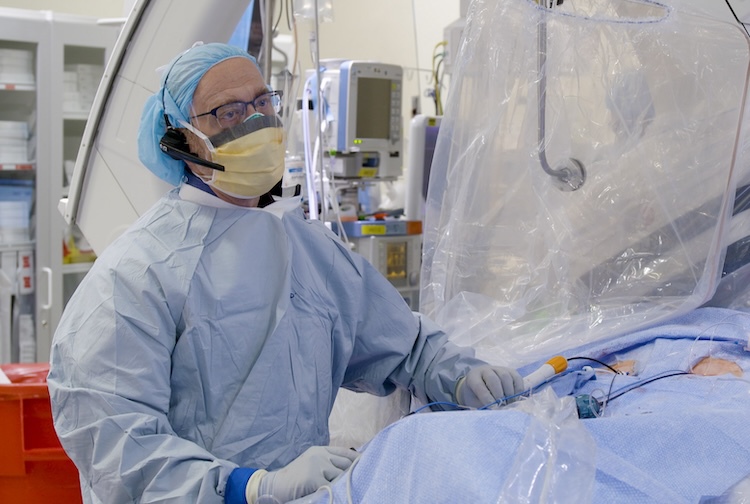 doctor in scrubs prepares for surgery