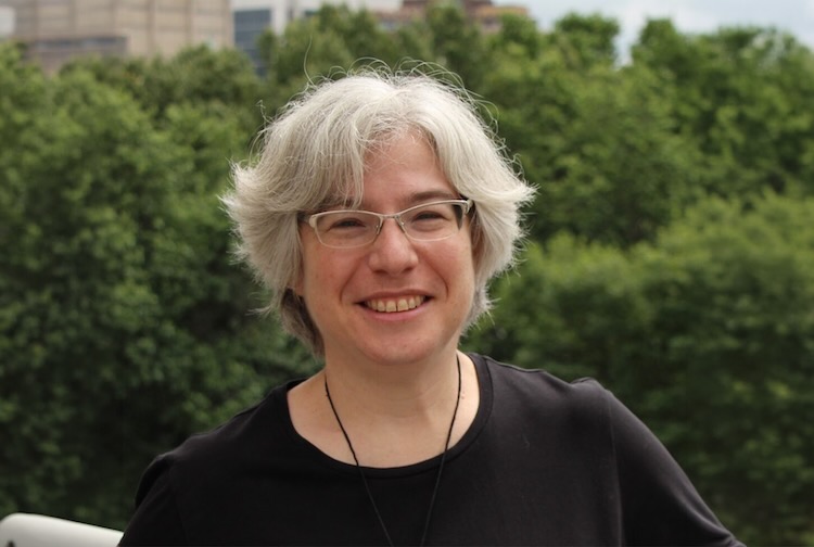 Dr. Etz wearing a black t-shirt standing outside.