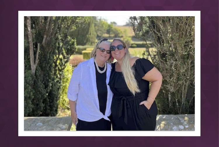 Mother and daughter standing in a garden
