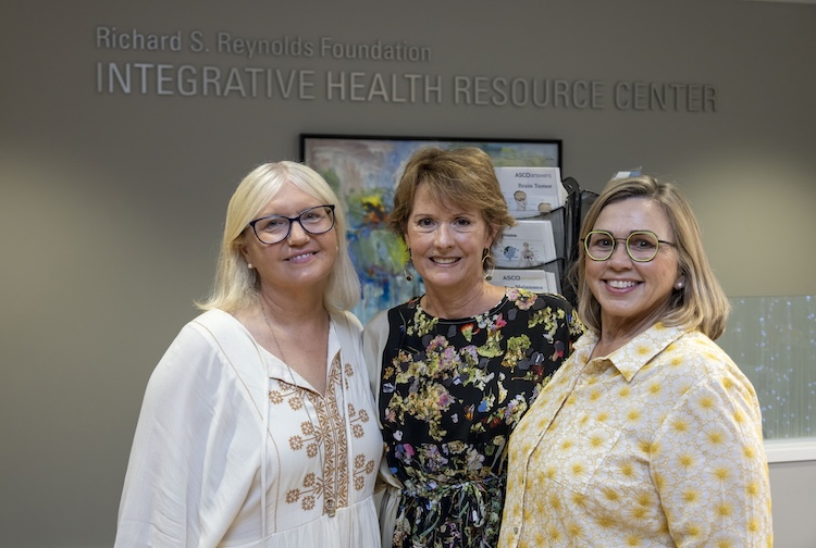 Three women standing together smiling