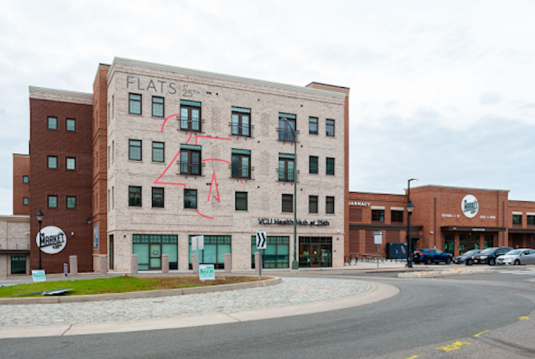Street view of the Health Hub near a rotary roundabout