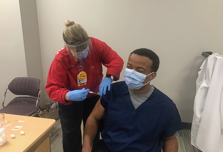 Jessica Johnson vaccinates Ikenna Ibe, MD, MPH, MBA, FACP, the Vice President of Medical Affairs & Chief Medical Officer at VCU Health CMH.