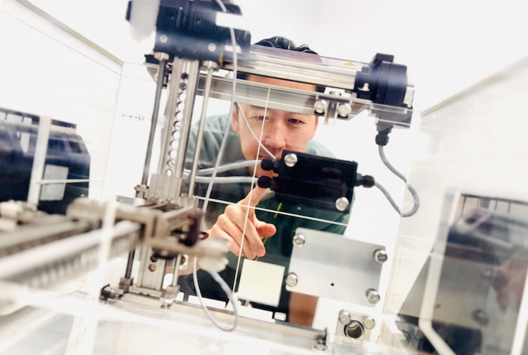 Man working on machine in lab.