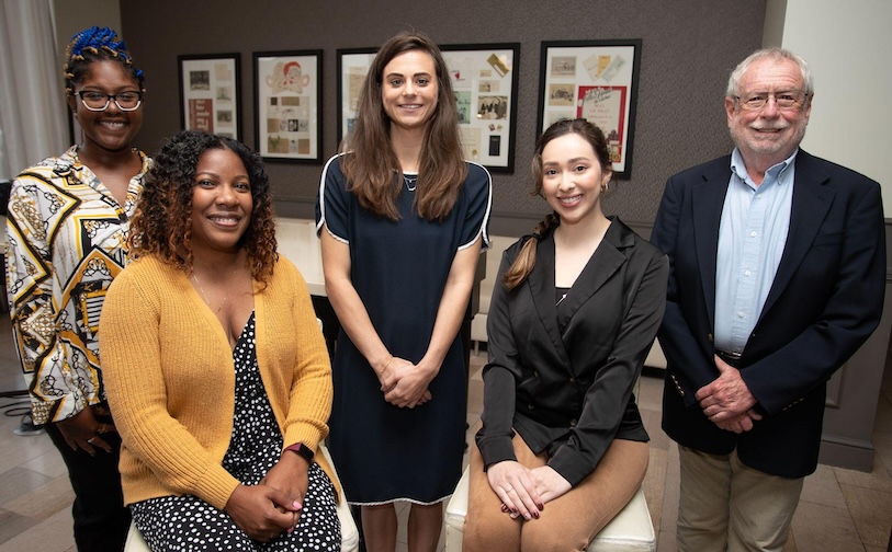 Group in business casual clothing, standing together and smiling