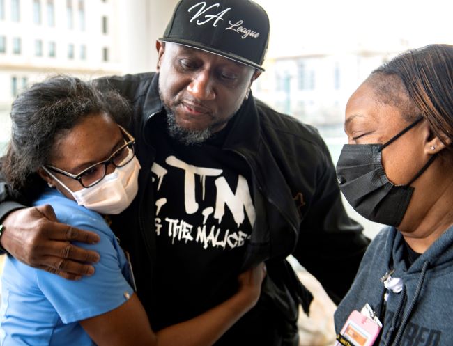 Paul Taylor gets a hug from a care team member