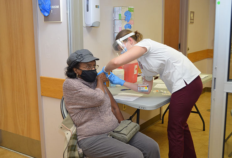 SVCC student Mikayle Baun of McKenney administered the first dose to Sarah Lassiter of South Hill on the second day of clinics.