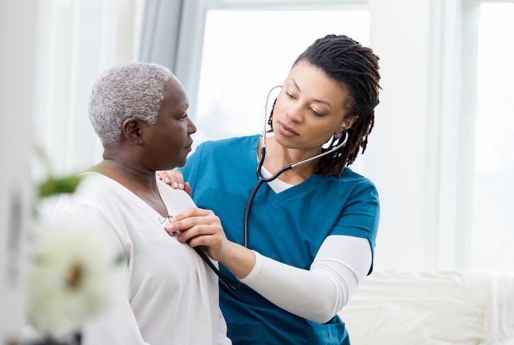 Female home healthcare providers checks patient's vital signs