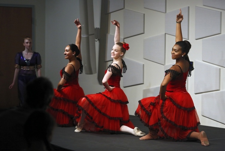 Three dancers in red dresses
