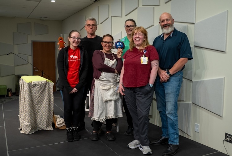 Group of people smiling on a stage