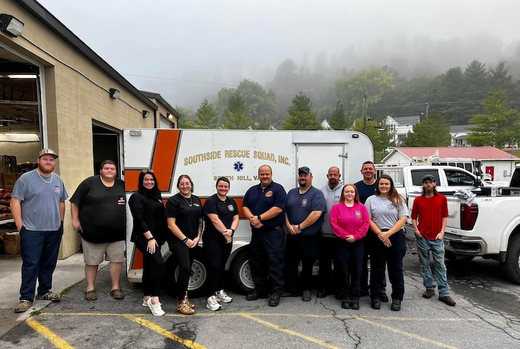 Members of Southside Rescue Squad stand near an ambulance 