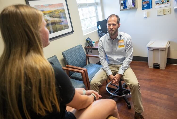 Dr. MacLean speaks with patient at the William & Mary clinic in Williamsburg