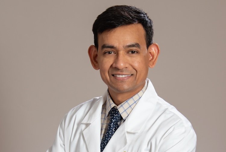 Man in lab coat smiling