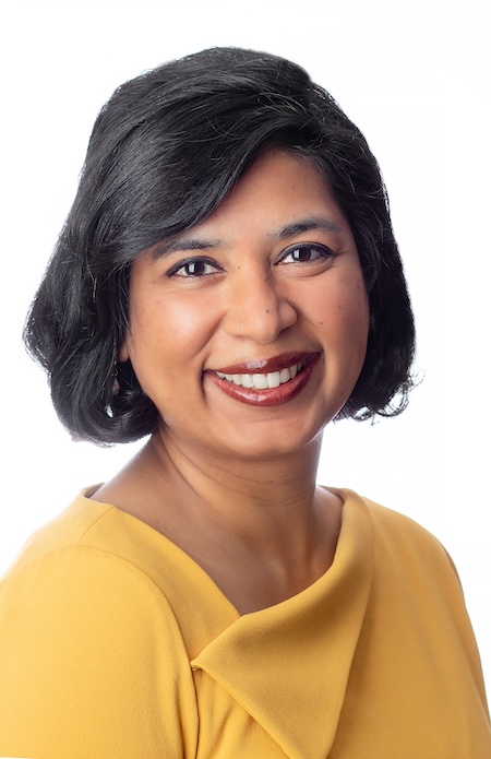 Dr. Bansal in a yellow blouse.