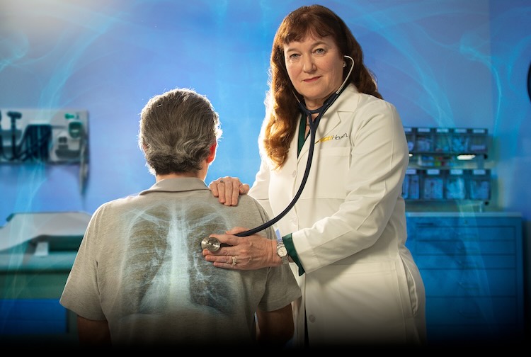 Dr. Sime holding stethoscope to patient's back