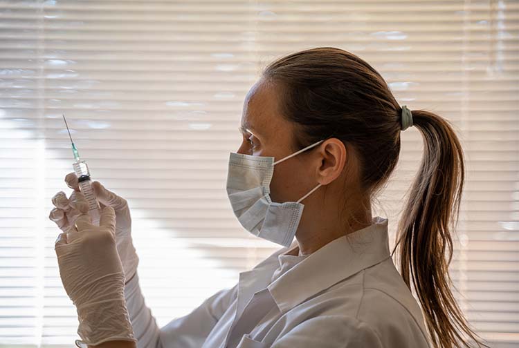 Woman preparing a syringe for vaccination