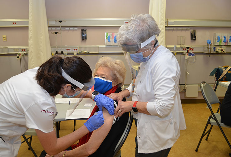 SVCC student Victoria Ezell of Lacrosse vaccinated Jean Clay Bagley of South Hill as Patty Mayer, RN, monitors.