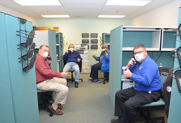 Volunteers Will Woodall, Tom Watters, Dot Saunders and Kenny Pitts answer calls to book COVID vaccine appointments at VCU Health CMH.