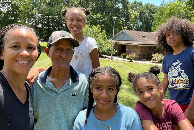 Family poses outside of the North Carolina Welcome Center on I-85.