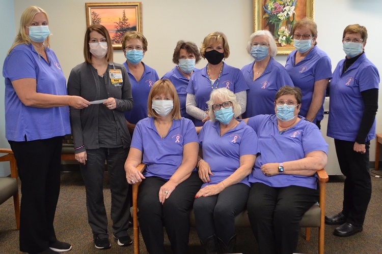 Ladies of the Lake Cancer Support Team donating fundraiser proceeds to CMH team