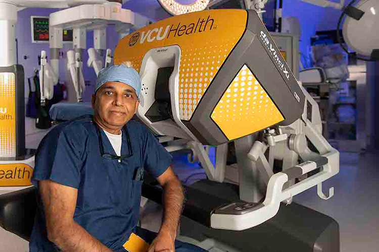 A surgeon next to a da Vinci surgery device.