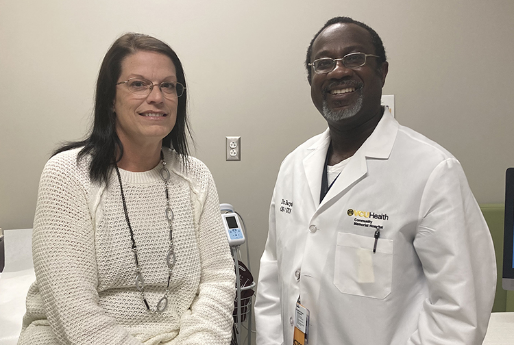 A patient poses for a photo with her doctor.