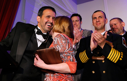 People clapping and hugging at the Shining Knight Gala event.