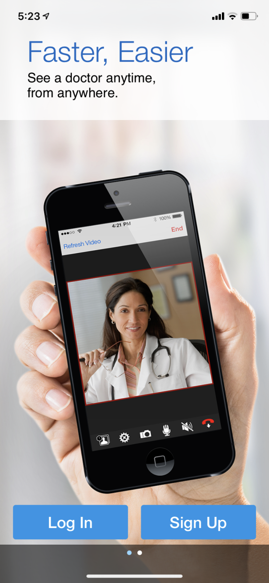 Hand holding a mobile phone, showing Log in or Sign Up options