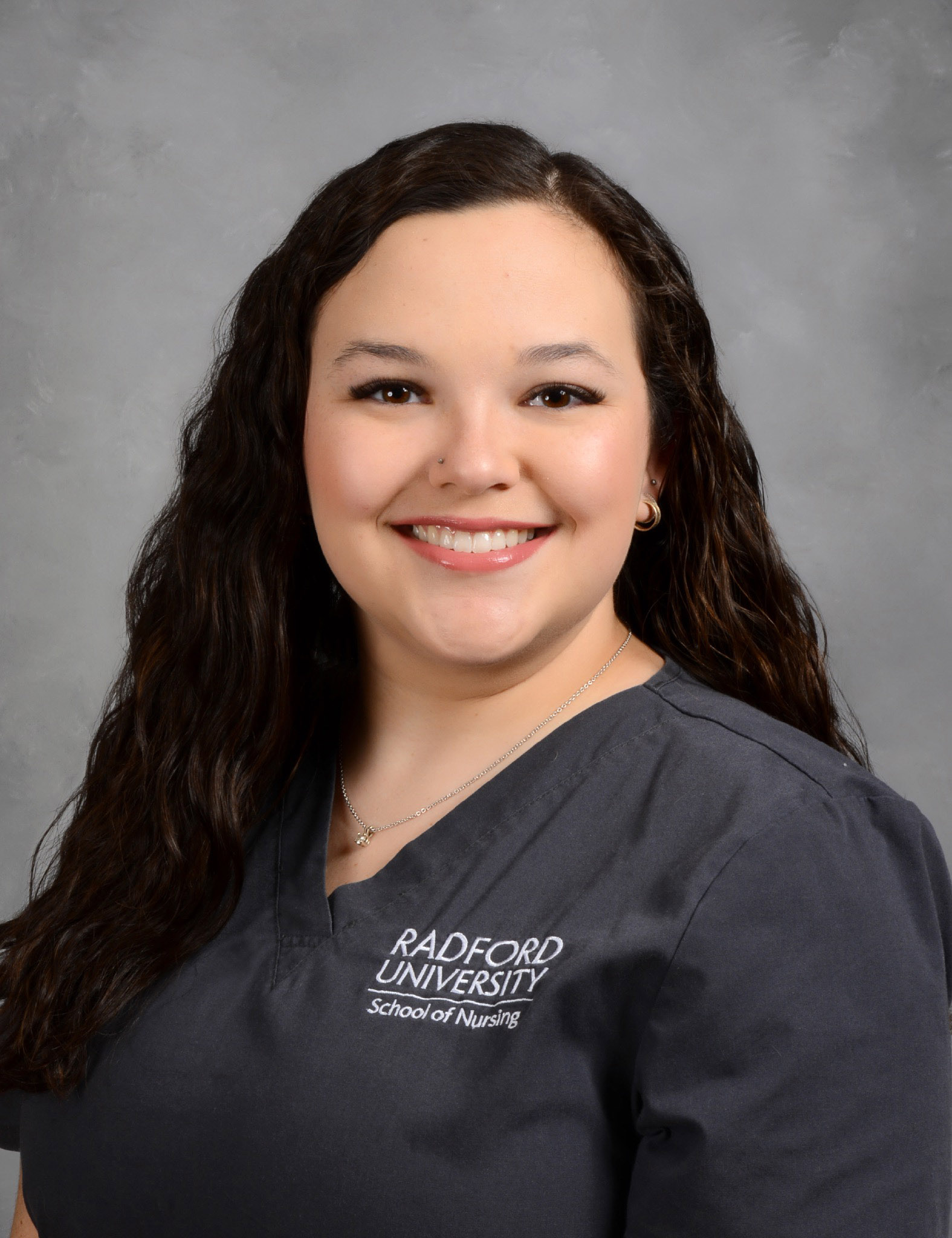 Nurse wearing grey scrubs.