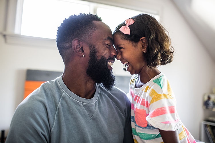 Father and daughter looking at each other and smiling