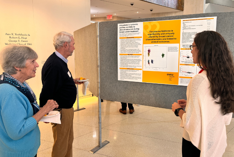 A Pauley Heart Center postdoctoral fellow explains her research to Pauley donors.