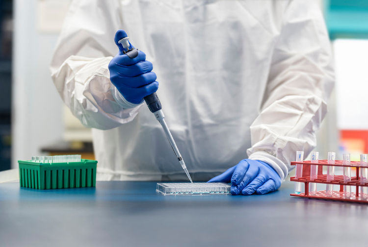 A researcher pipetting in a lab